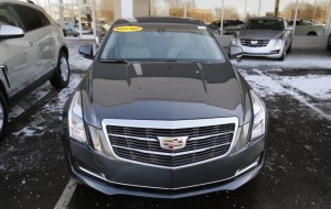 An unsold Cadillac ATS vehicle sits in the front lot of a Cadillac automobile dealership in Plymouth