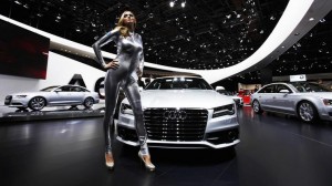 A model poses in front of an Audi A7 during the press day for the North American International Auto show in Detroit