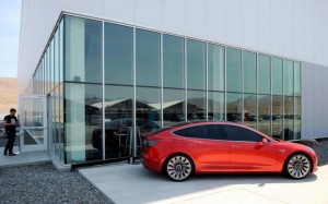 FILE PHOTO: A prototype of the Tesla Model 3 is on display in front of the factory during a media tour of the Tesla Gigafactory which will produce batteries for the electric carmaker in Sparks